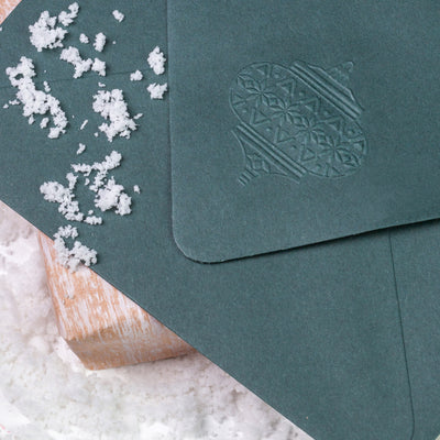 Green envelope flap embossed with Christmas bauble | Heirloom Seals