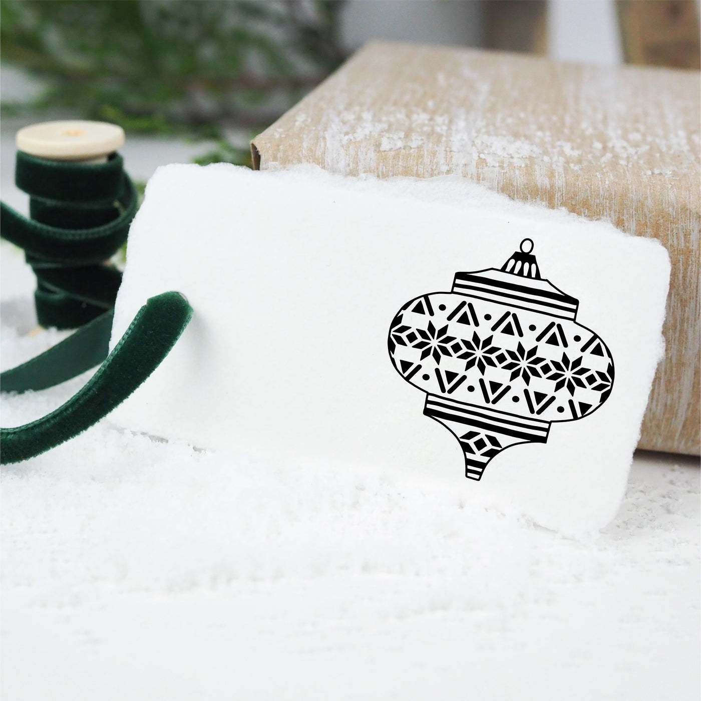 White gift tag stamped with Christmas bauble and tied with velvet green ribbon | Heirloom Seals