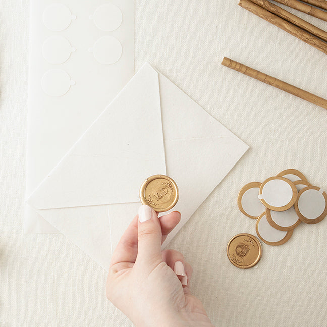 Holding Pre-Made Wax Seal Sticker Above Envelope Flap | How To Use Self-Adhesive Seals | Heirloom Seals