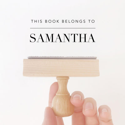 Woman using her personalised Samantha wooden library book stamp