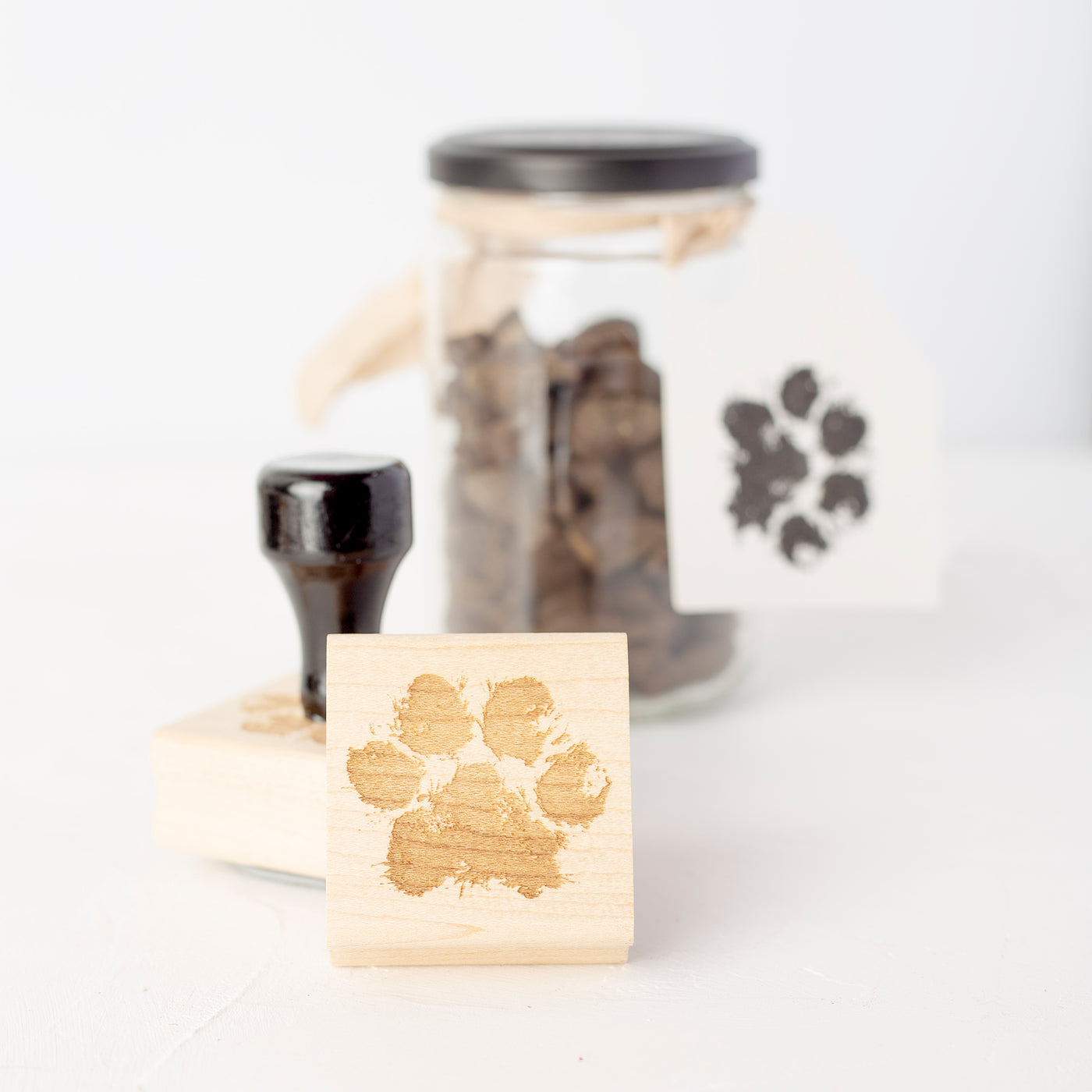 Dog treat jar decorated with customised paw print stamp with wooden handle