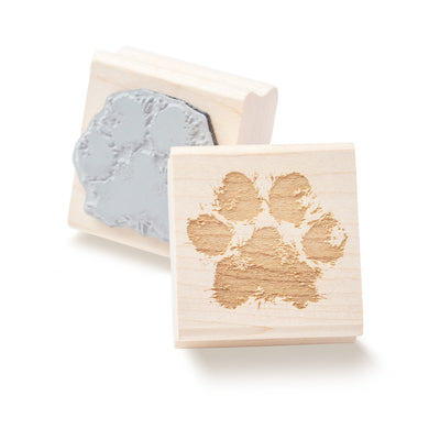 Front and back of a dog's paw printed on a wooden stamp