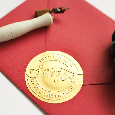 Gold Official Santa Seal Embossed Sticker on Red Envelope | Believe Christmas Collection | Heirloom Seals