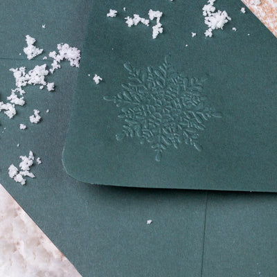 Green envelope flap embossed with Christmassy snowflake | Heirloom Seals