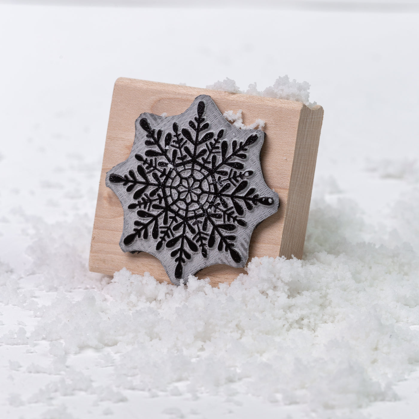 Winter snowflake wooden rubber stamp in the snow | Heirloom Seals