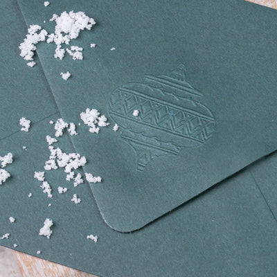 Green envelope flap embossed with Christmas bauble | Heirloom Seals