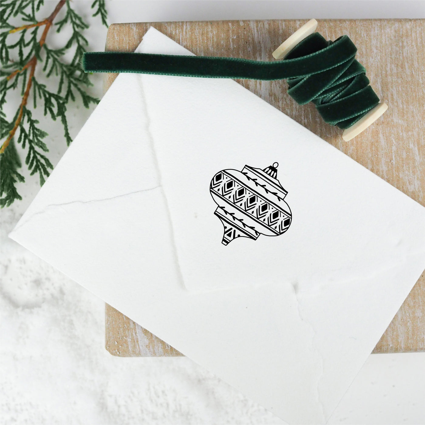The back of a white envelope stamped with a vintage Christmas bauble design | Heirloom Seals