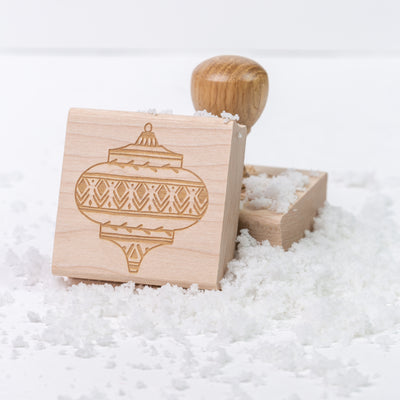 Christmas wooden rubber stamps with and without handles on a bed of snow | Heirloom Seals